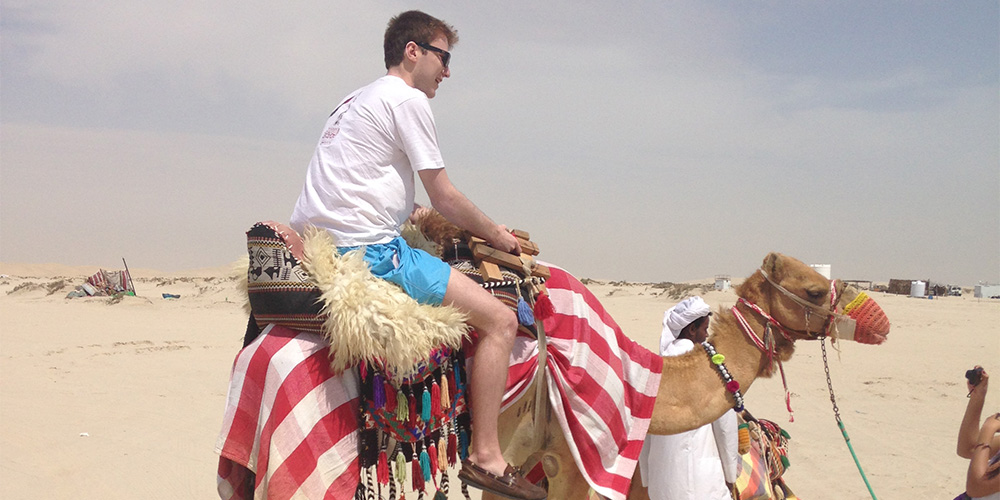 BSJ Student riding a camel in Qatar.